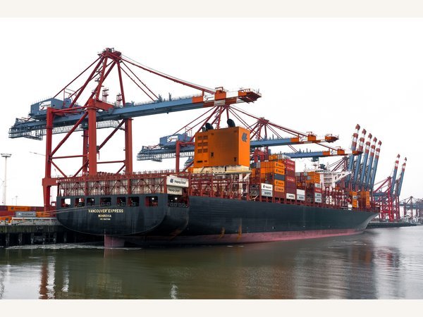 Cargo vessel alongside port cranes