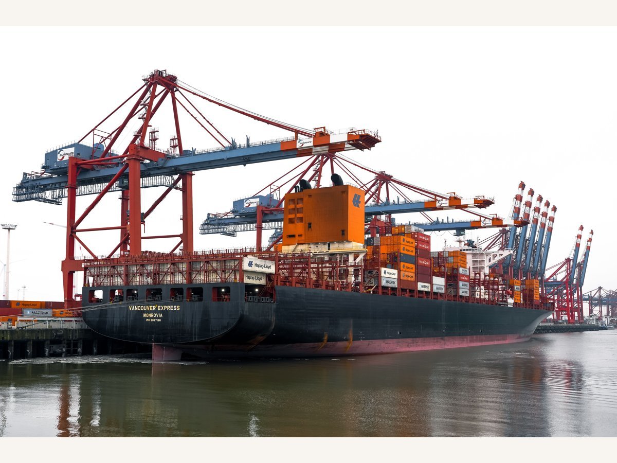 Cargo vessel alongside port cranes