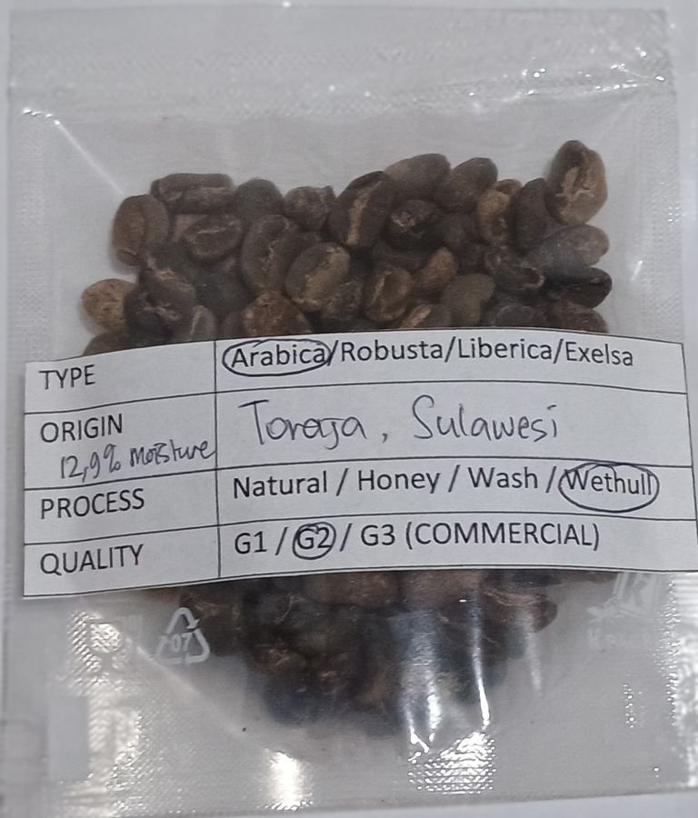 Indonesian coffee sample packet with a handwritten specification label